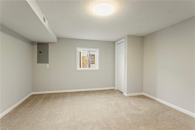 basement with electric panel, carpet floors, and a textured ceiling