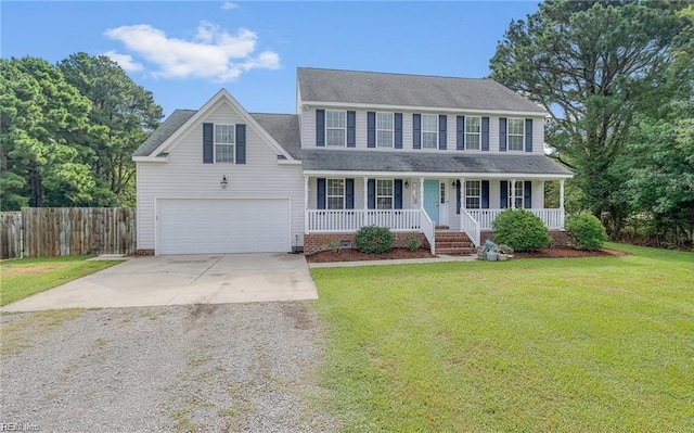 colonial-style house with a garage, a front yard, and covered porch