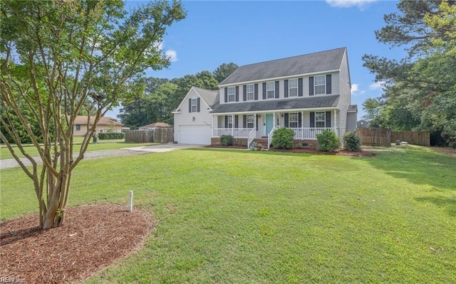 colonial home with a porch, a garage, and a front lawn