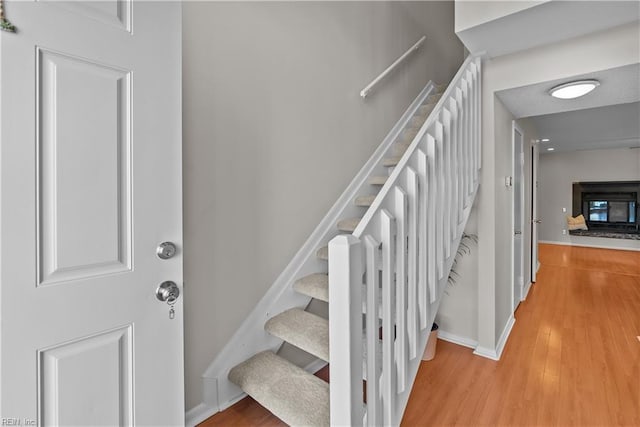 stairs with hardwood / wood-style flooring