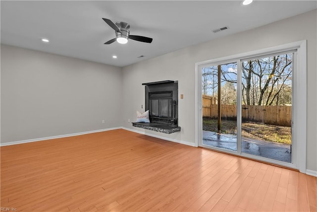 unfurnished living room with ceiling fan and light wood-type flooring