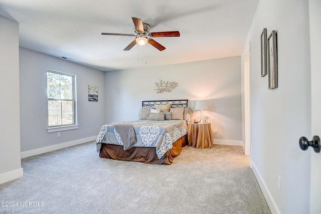 bedroom with ceiling fan and carpet flooring