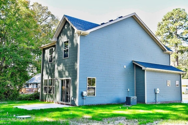 back of house featuring a patio, central AC, and a lawn