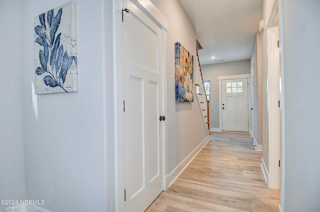 hall with light hardwood / wood-style floors