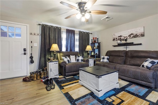 living room with light hardwood / wood-style flooring and ceiling fan