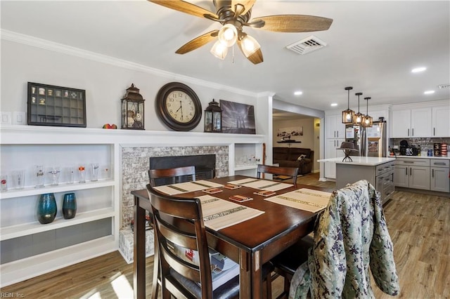 dining room featuring crown molding, ceiling fan, and dark hardwood / wood-style floors