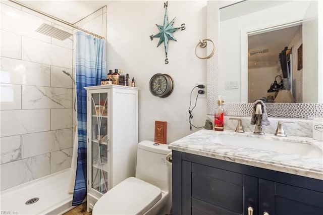 bathroom featuring vanity, a shower with curtain, and toilet