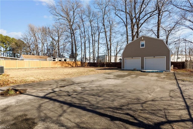 view of property exterior with an outbuilding, a garage, and central air condition unit