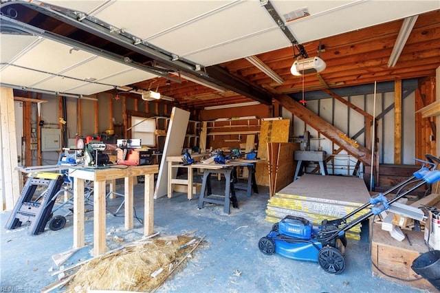 garage featuring a garage door opener and a workshop area