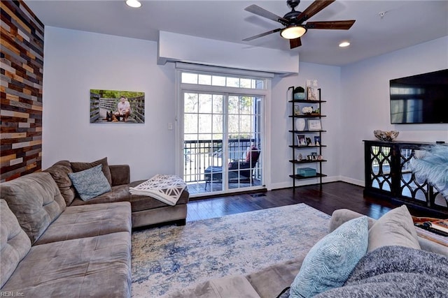 living room featuring dark hardwood / wood-style flooring and ceiling fan