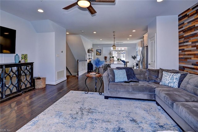 living room featuring dark hardwood / wood-style floors and ceiling fan