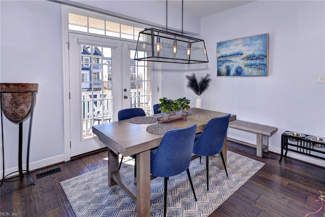 dining space featuring dark hardwood / wood-style floors and french doors