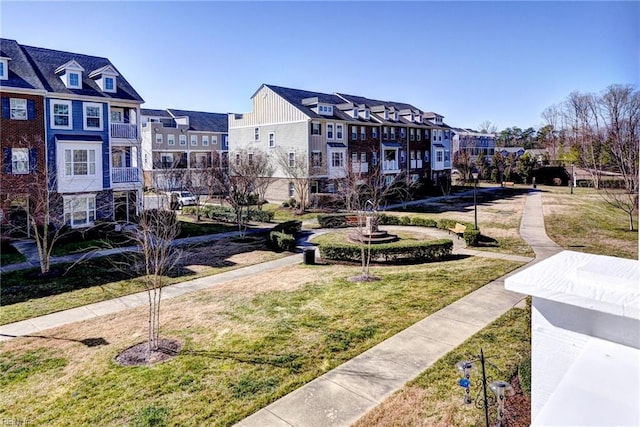 view of property's community with a yard