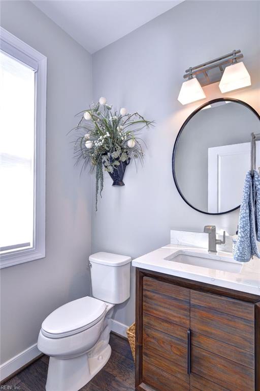 bathroom with vanity, hardwood / wood-style flooring, and toilet