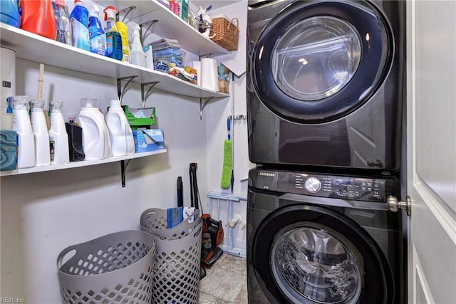 clothes washing area with stacked washing maching and dryer