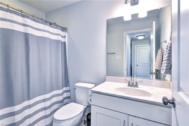 bathroom with vanity, a shower with curtain, and toilet