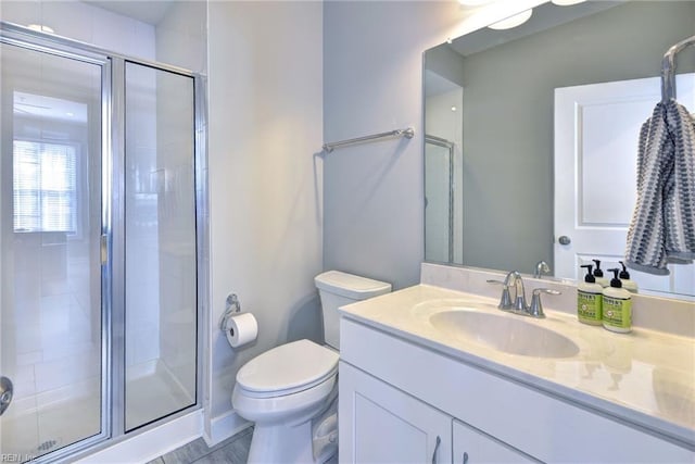 bathroom with vanity, toilet, and walk in shower