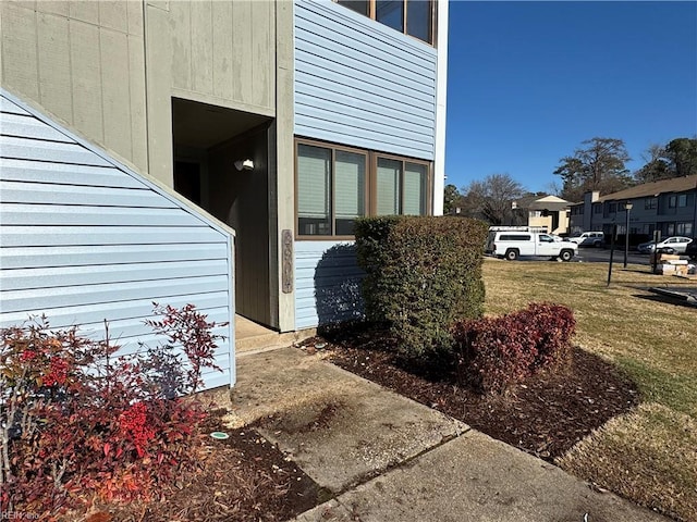 view of side of home featuring a lawn