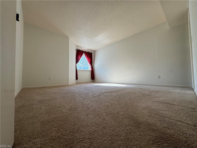 unfurnished room featuring carpet floors and a textured ceiling