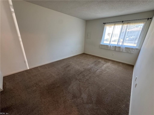 empty room with carpet flooring and a textured ceiling