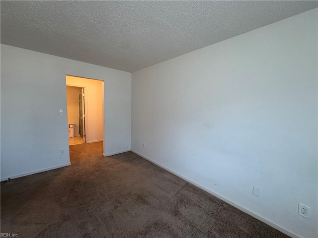 carpeted spare room with a textured ceiling