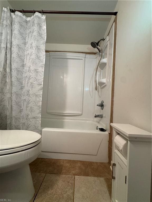 bathroom featuring shower / tub combo with curtain, tile patterned floors, and toilet