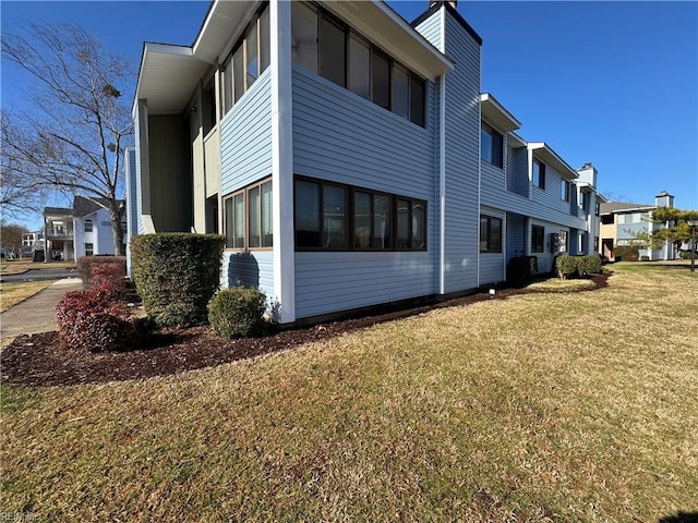 view of property exterior featuring a lawn