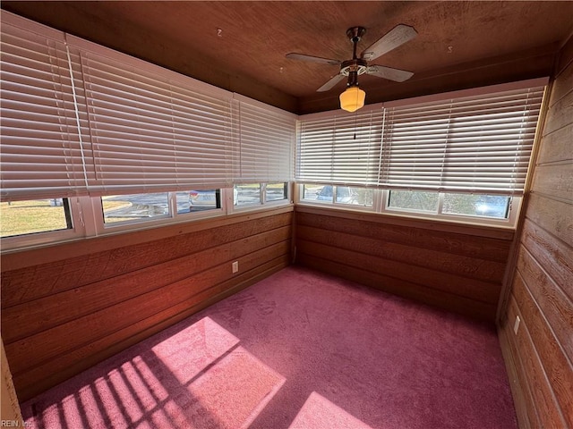 unfurnished sunroom with ceiling fan