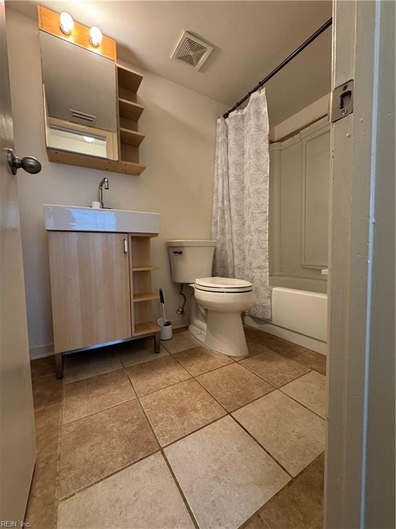 full bathroom with tile patterned flooring, shower / bath combo, vanity, and toilet