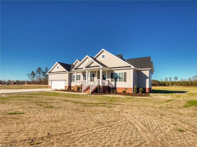 craftsman-style home with a porch, a garage, and a front yard