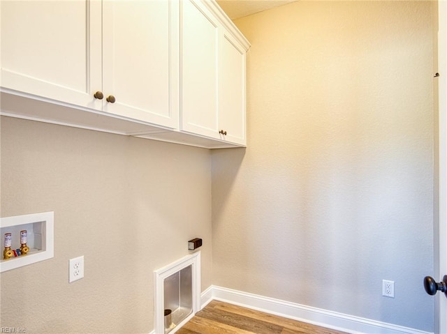 laundry room featuring cabinets, hookup for a washing machine, and light wood-type flooring