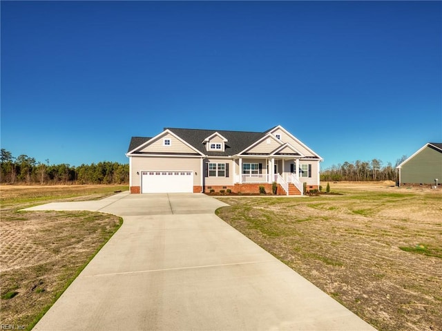 view of front facade with a porch, a garage, and a front lawn