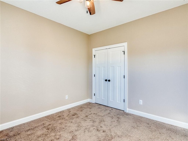 unfurnished bedroom featuring ceiling fan, carpet flooring, and a closet