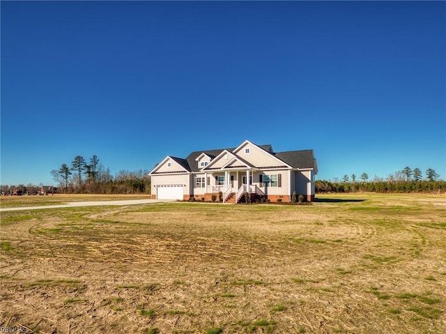 craftsman inspired home with a garage, a front lawn, and a porch