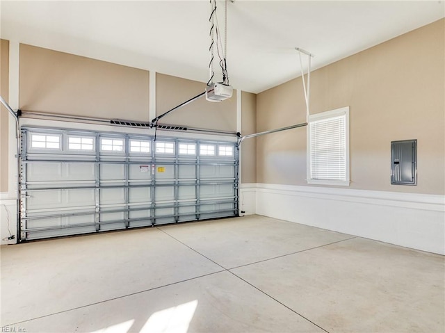 garage with a garage door opener and electric panel