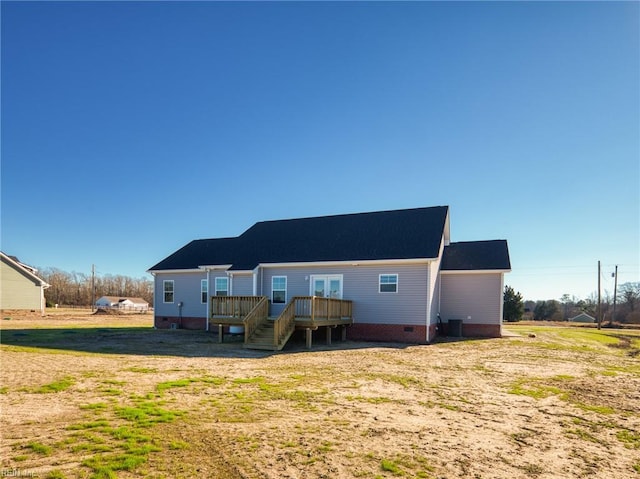 back of property featuring a wooden deck