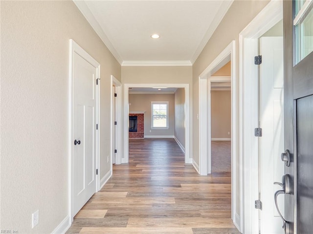 hall featuring crown molding and light hardwood / wood-style flooring