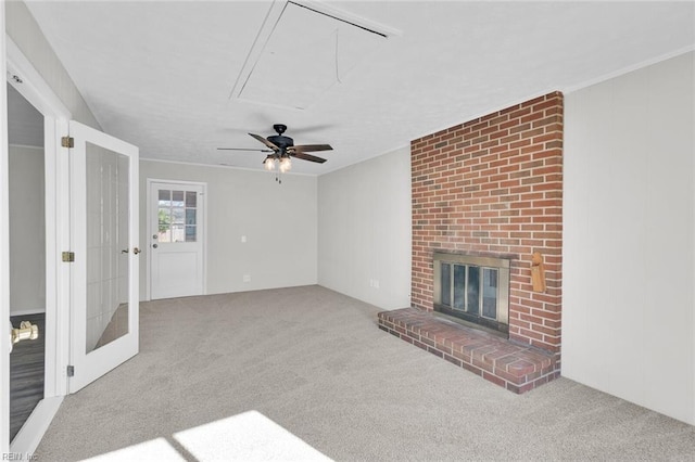 unfurnished living room with crown molding, a brick fireplace, and carpet