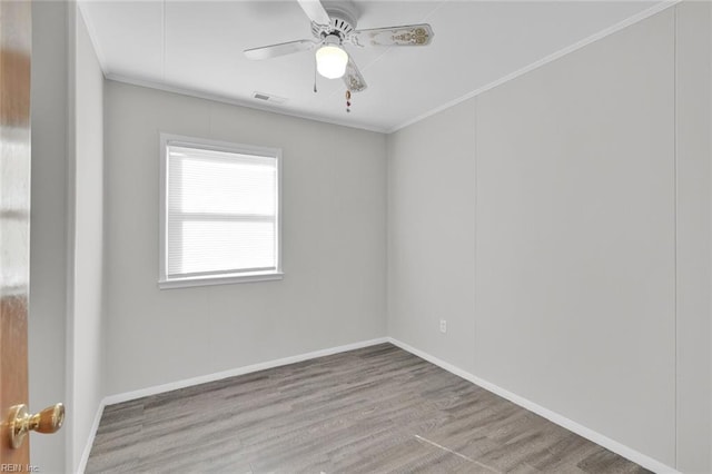 unfurnished room with ornamental molding, ceiling fan, and light wood-type flooring