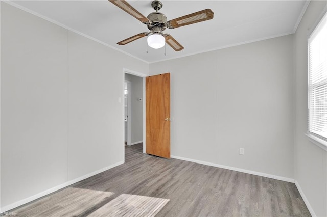 unfurnished room with crown molding, ceiling fan, and light wood-type flooring