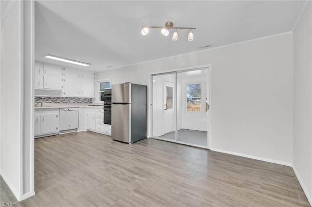 kitchen featuring white cabinets, stainless steel fridge, white dishwasher, light hardwood / wood-style floors, and crown molding