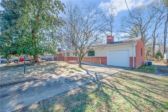 view of front of house featuring a garage and central AC unit