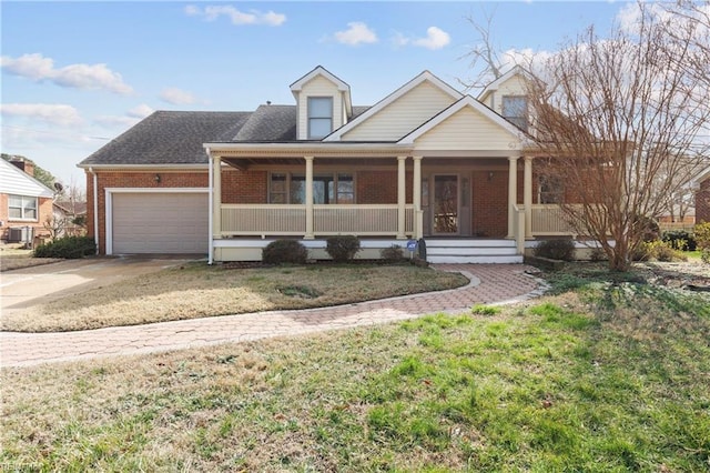 view of front facade with a porch, a garage, and a front yard