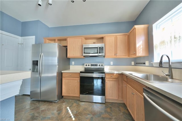 kitchen featuring stainless steel appliances, sink, and light brown cabinets