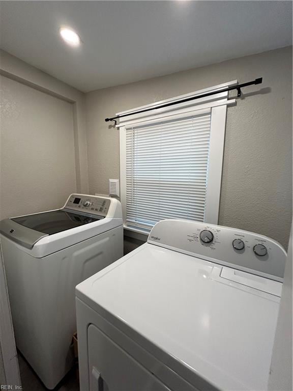 clothes washing area featuring independent washer and dryer