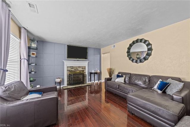 living room with wood-type flooring and a fireplace