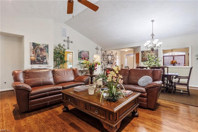 living room featuring ceiling fan with notable chandelier, hardwood / wood-style floors, and high vaulted ceiling