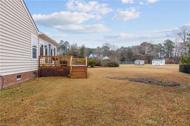 view of yard with a wooden deck and a shed