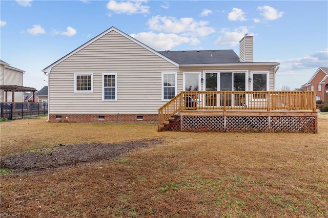 rear view of property with a wooden deck and a yard