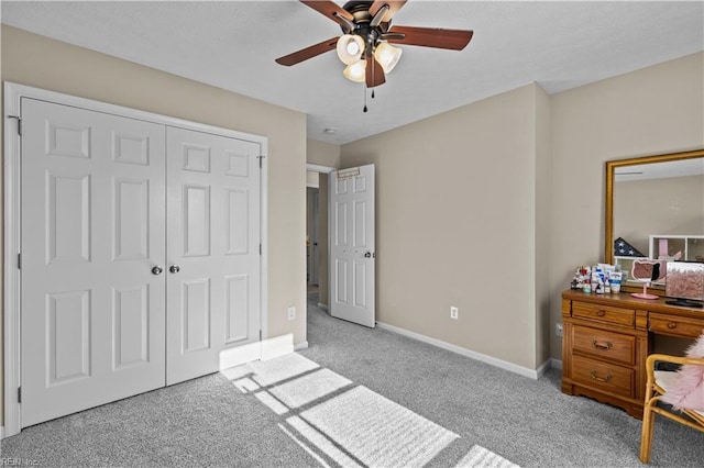 bedroom featuring light carpet, ceiling fan, and a closet